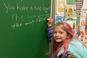  Student writing on chalkboard